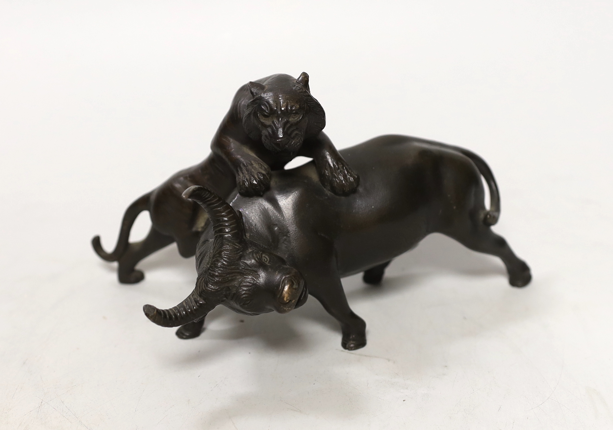 A Japanese bronze ‘tiger and ox group’, Meiji period, signed Seiya saku, 17cm